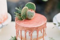 a naked wedding cake with copper dripping, thistles and cacti for a desert wedding