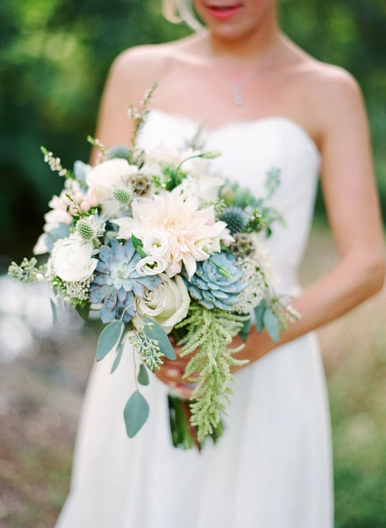 a neutral wedding bouquet with thistles, greenery and succulents is a lovely idea for a spring or summer wedding in neutrals