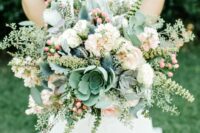 a pastel wedding bouquet of white and blush blooms, succulents, thistles, greenery and berries is a very sweet and cool idea