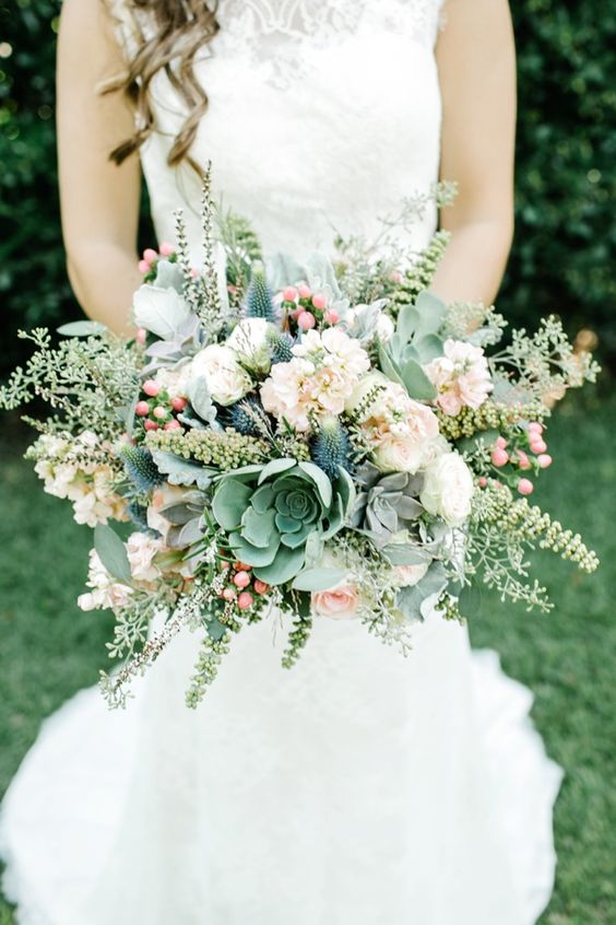 a pastel wedding bouquet of white and blush blooms, succulents, thistles, greenery and berries is a very sweet and cool idea