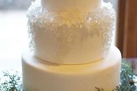 a plain white wedding cake decorated with white sugar rocks is gorgeous for a modern wedding