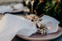 a pretty seashell napkin ring is a perfect solution for a costal or a beach wedding and it looks bold and fresh