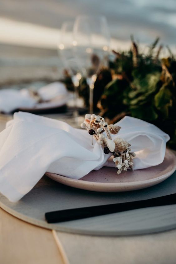 a pretty seashell napkin ring is a perfect solution for a costal or a beach wedding and it looks bold and fresh