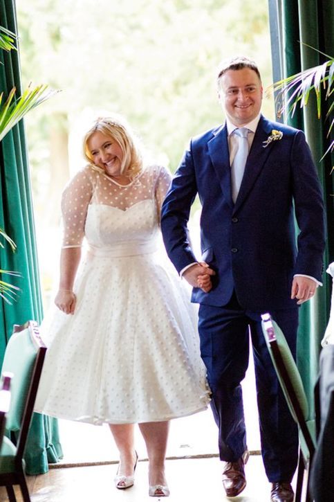 a retro tea length polka dot wedding dress with an illusion neckline and short sleeves plus peep toe wedding shoes