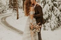 a romantic A-line off the shoulder wedding dress with lace inserts for a winter elopement in the woods