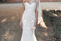 a romantic one shoulder mermaid wedding dress with floral lace applique, a short sleeve and a train for a romantic bride