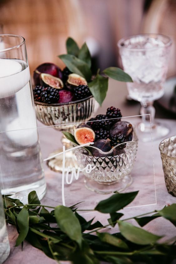 a sheer acrylic table number and crystal bowls with figs and blackberries for decadent fall table decor