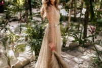 a sheer fully embellished A-line wedding dress with illusion sleeves and a train for a tropical elopement