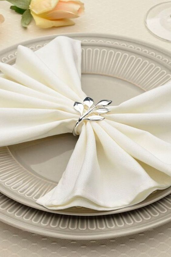 a silver leaf napkin ring won't wither and will add a glam and shiny touch to your tablescape while looking chic