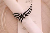 a striped black and white napkin wrap is a chic and bold idea for a chic and refined tablescape in any season