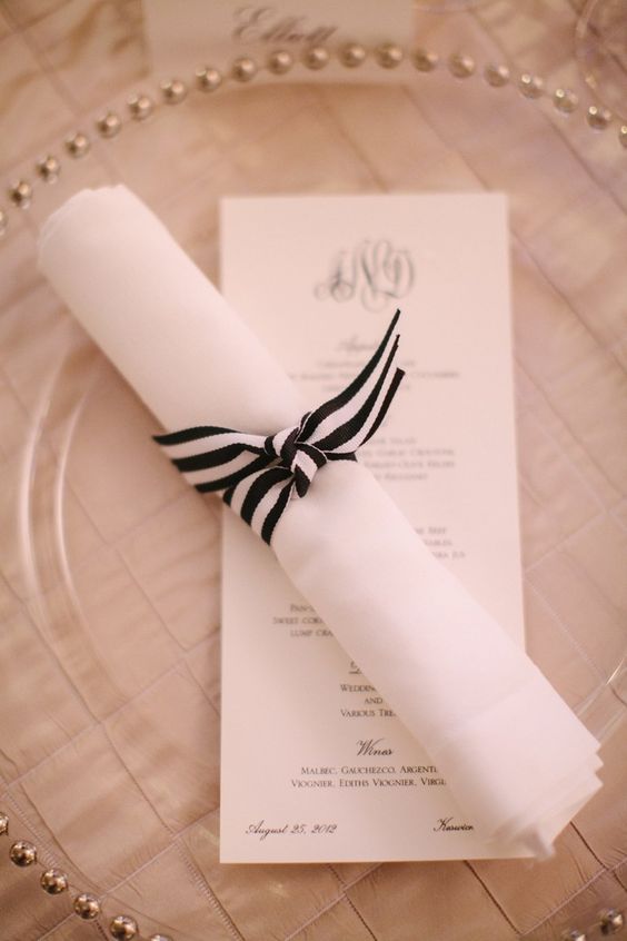 a striped black and white napkin wrap is a chic and bold idea for a chic and refined tablescape in any season