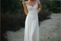 a stylish 1920s embellished wedding dress with a V-neckline, embellished cap sleeves, a train is a lovely idea for a vintage look