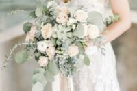 a subtle wedding bouquet of white and pastel blooms, greenery and a succulent is a delicate and chic idea for spring and summer