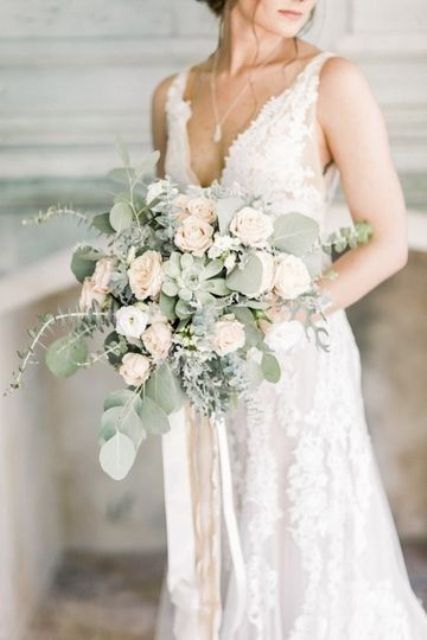 a subtle wedding bouquet of white and pastel blooms, greenery and a succulent is a delicate and chic idea for spring and summer