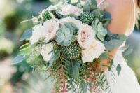 a summer or desert wedding bouquet of blush roses, succulents, cacti and berries and greenery is amazing