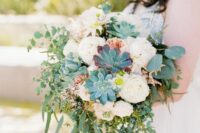 a summer wedding bouquet of white and blush blooms, succulents and greenery and grasses of various kinds