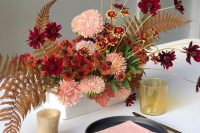 a super bright box wedding centerpiece with pink, rust and burgundy blooms, dried fern leaves looks spectacular