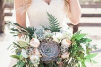 a super lush wedding bouquet of white and blush peony roses, greenery and foliage plus large succulents