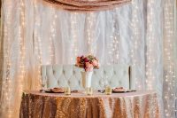 a sweetheat table covered with a copper sequin tablecloth and a copper sequin runner in the backdrop