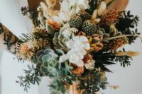 a textural and dimenstional wedding bouquet with white and orange blooms, succulents, cacti, grasses and peachy ribbons