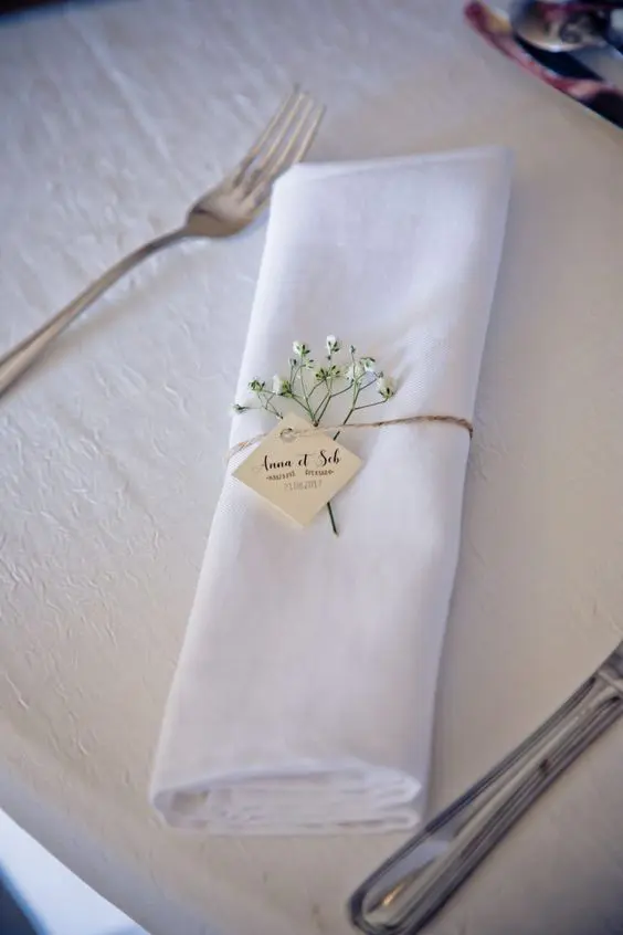 a twine napkin ring with baby's breath and a little name tag instead of a palce card is a very chic and lovely idea