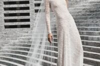 a unique textural semi-fitting wedding dress with one long sleeve and rhinestones is a bold idea for those who want to impress