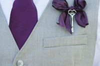 a vintage boutonniere of a purple bow that echoes with the tie and a vintage key is a lovely accessory for a fall wedding