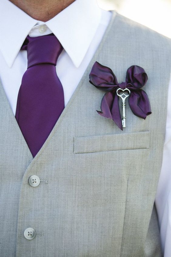 a vintage boutonniere of a purple bow that echoes with the tie and a vintage key is a lovely accessory for a fall wedding