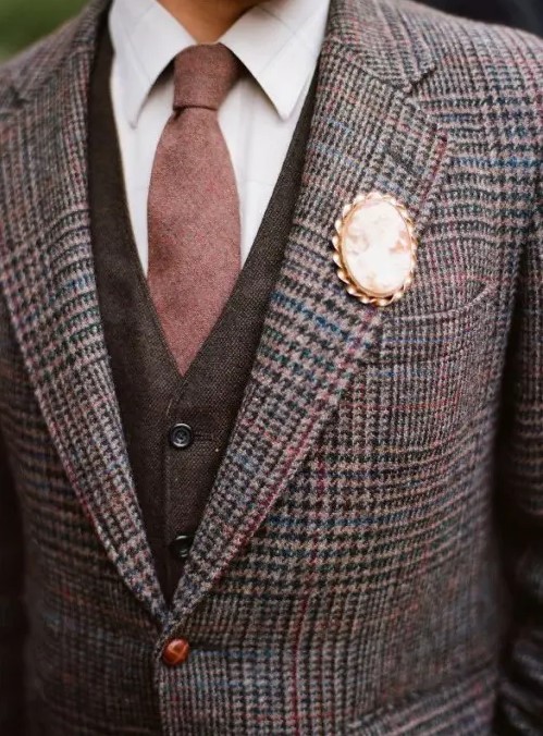 a vintage brooch instead of a boutonniere looks elegant and sticks to the vintage inspired style of the groom