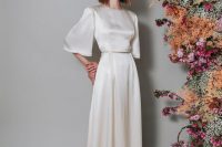 a vintage-inspired bridal look with a silk A-line wedding dress, wide bell sleeves, a high neckline, a train is a lovely idea to try, and silk guarantees timeless elegance