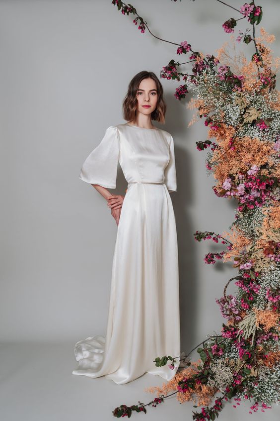 a vintage inspired bridal look with a silk A line wedding dress, wide bell sleeves, a high neckline, a train is a lovely idea to try, and silk guarantees timeless elegance