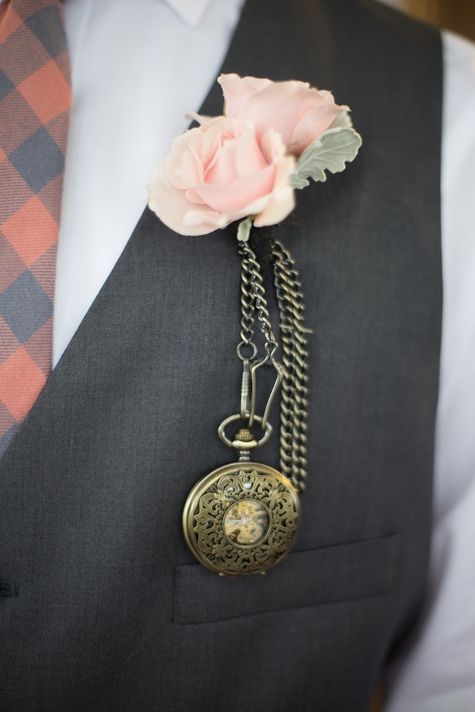 a vintage wedding boutonniere of pink roses, pale leaves and a refined pocket watch is amazing for a wedding