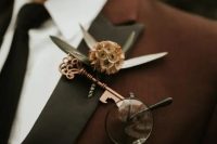 a wedding boutonniere of a vintage copper key, a seed pod and greenery is a dreamy idea for a fairy tale wedding or for a Halloween one