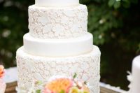 a white floral pattern wedding cake with plain tiers is a real masterpiece for a garden wedding