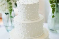 a white pearl and bead wedding cake is a cute and sweet dessert for a modern glam wedding