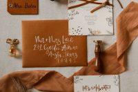 an amber wedding invitation suite with suede and leather and stylish printing is bright and cool