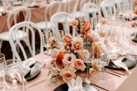 an elegant fall wedding centerpiece with blush, rust and creamy blooms and plenty of texture is timeless