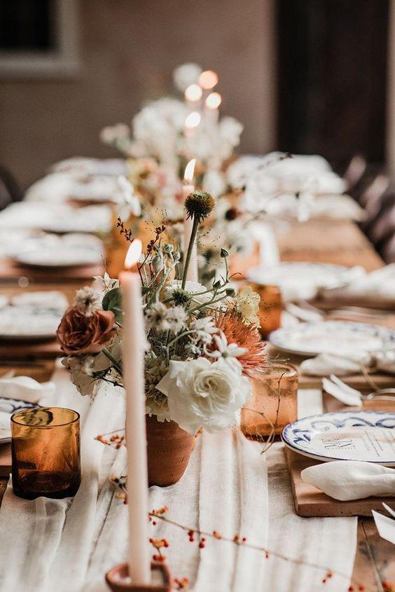 an elegant fall wedding tablescape spruced up with amber glasses and cutlery, rust and amber blooms