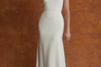 an ultra-minimalist one shoulder semi-fitting wedding dress with a sash and a train – you won’t need anything else to make a statement