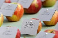 apples with cards pinned are wedding favors and escort cards at the same time