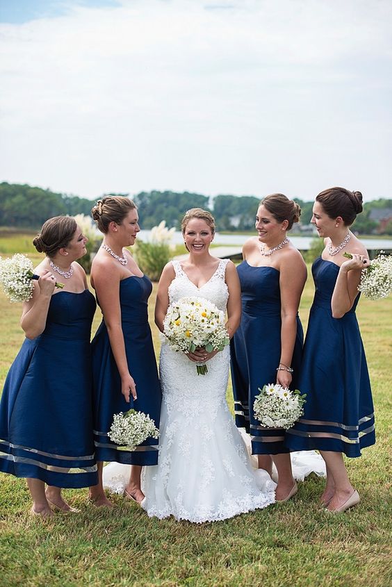 chic and elegant strapless navy and clear A-lien bridesmaid dresses, statement necklaces and nude shoes for a bold summer wedding