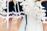 elegat and classic sleeveless navy and white bridesmaid dresses with high necklines and nude shoes are perfect for a nautical wedding