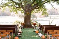 fall leaves and pumpkins to line up the aisle and bold fall blooms to accent the ceremony space