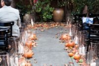 fall leaves, pumpkins with candles in glass candle holders to line up your wedding aisle outdoors
