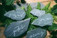 rocks as place or escort cards put on ferns are lovely pieces for fall or winter weddings