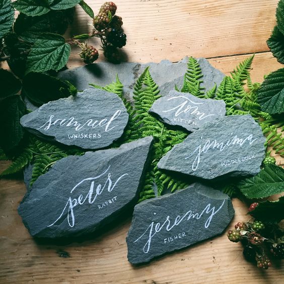 rocks as place or escort cards put on ferns are lovely pieces for fall or winter weddings