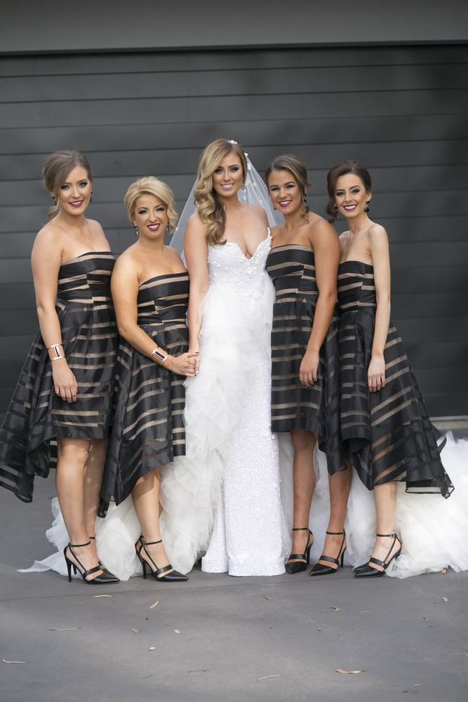 strapless black and tan A-line high low bridesmaid dresses and matching black shoes for a sexy look
