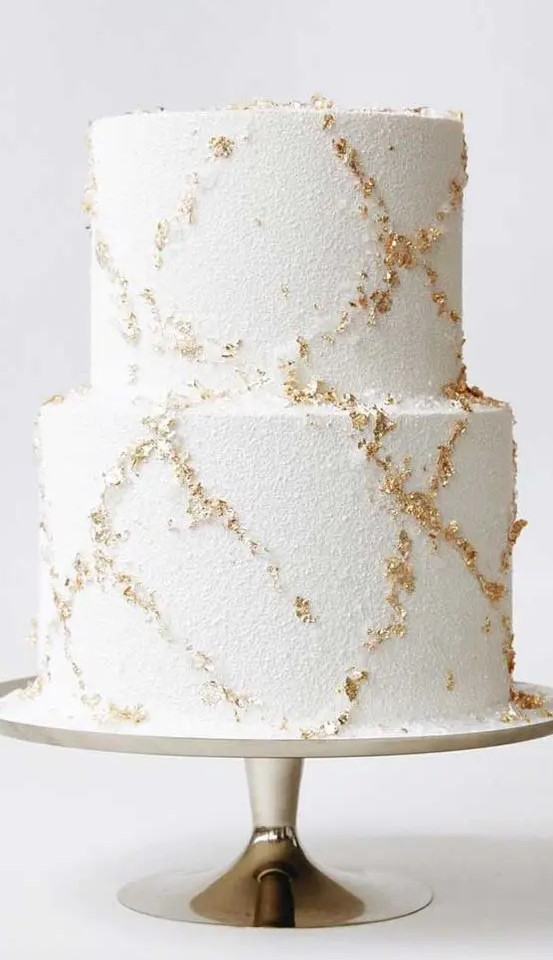 a beautiful wedding cake with gold leaf is a very stylish and beautiful idea to rock for a winter wedding