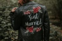 a black leather jacket with colorful floral handpainting is a trendy fall coverup idea to rock