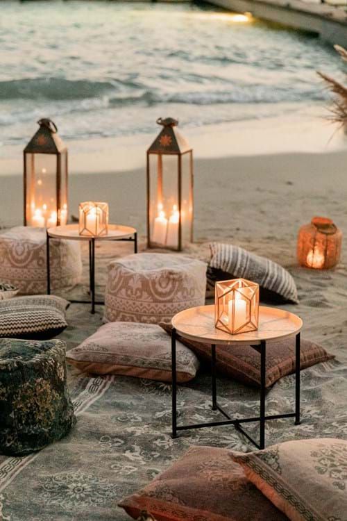a boho beach wedding lounge with candle lanterns, lots of cushions and blankets is amazing for a destination wedding